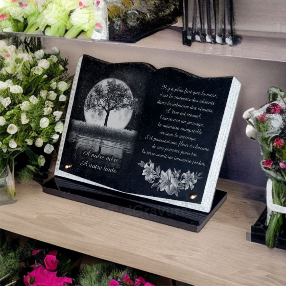 Plaque mortuaire en granit forme livre avec fleurs et arbre de vie